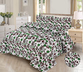 Floral patterned comforter set on a bed in a bedroom setting